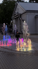 Colorful illuminated fountain lights up a Jūrmala square at night