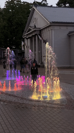 Colorful illuminated fountain lights up a Jūrmala square at night