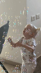Child plays with bubble gun indoors Friday morning
