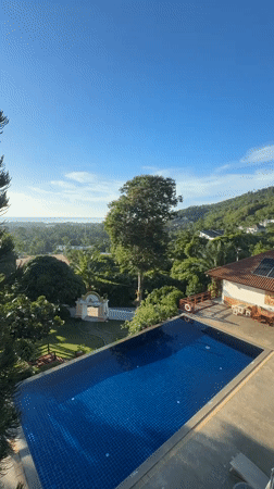 Hillside pool with sweeping green views on a clear day