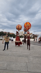 Hot air balloon stilt performers parade through Sofia plaza