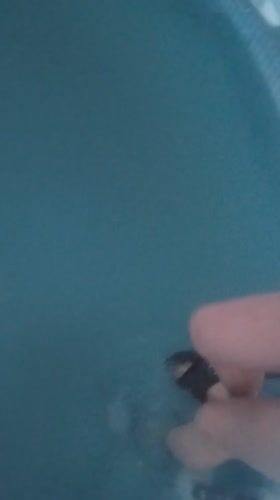 Woman in pink swimsuit braves snow for pool dip