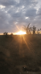 Sunset and rainbow over a quiet rural landscape