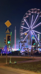 Night amusement park lights captured near Riga traffic intersection
