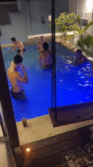 Young men enjoy nighttime swim in Playa del Carmen