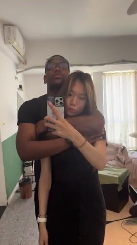 Couple takes mirror selfies in Liangjiang apartment