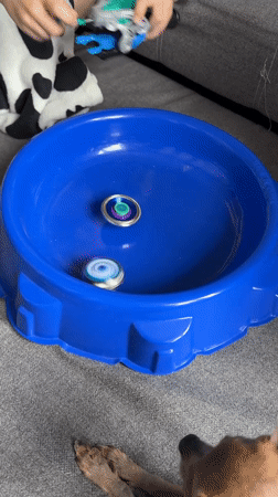 Child plays with Beyblades on couch in Chaikovsky