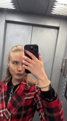 Woman Takes Mirror Selfies in Elevator