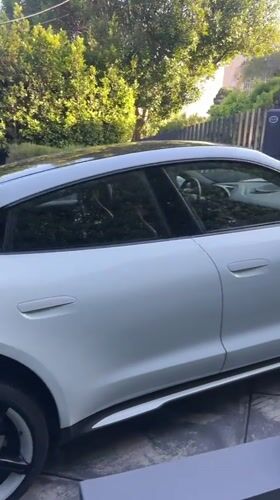 Late-night video production featuring white Porsche filmed in West Hollywood