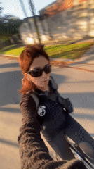 Two cyclists spotted on Monte Grande street during sunlit evening