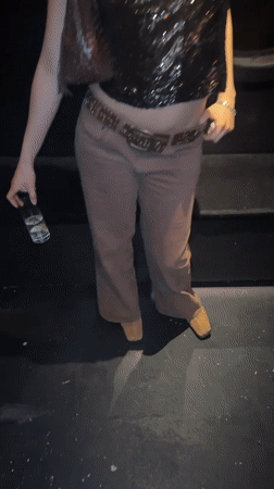 Woman poses for photo at London party