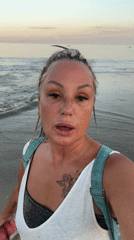 Woman walks barefoot on Indonesian beach at sunrise