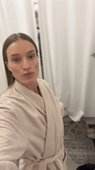 Woman tries on clothes in Oelde store fitting room