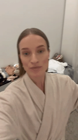 Woman tries on clothes in Oelde store fitting room