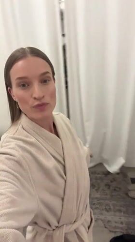 Woman tries on clothes in Oelde store fitting room