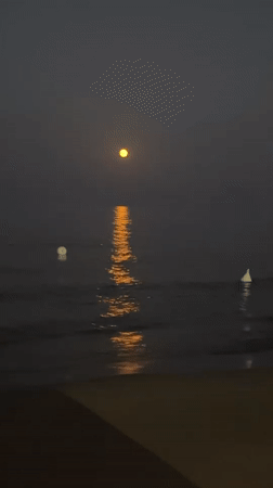 Full moon rising over calm Sardinian coastal waters