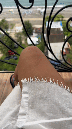 Quiet balcony moment in Batumi, white dress, late summer.