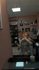 Woman takes selfie during hair treatment at Russian salon