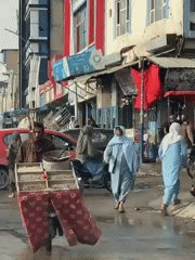 Daily life continues on wet Kandahar streets after rain