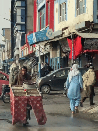 Daily life continues on wet Kandahar streets after rain