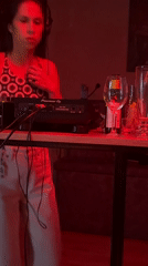 Late-night DJ set in a red-lit Kragujevac club