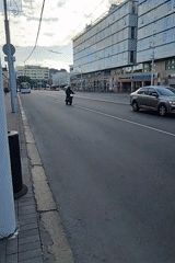 Urban street scene captures motorcycles, pedestrians at city intersection