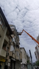 Utility workers conduct elevated building maintenance in Varna, Bulgaria