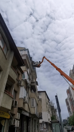 Utility workers conduct elevated building maintenance in Varna, Bulgaria