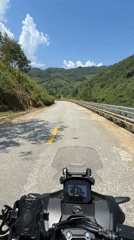 Motorcyclist rides mountain road near Đà Nẵng early morning