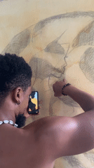 Artist creates large-scale drawing in Ado studio session