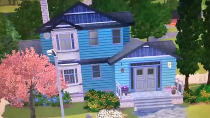The video opens with a blurry shot of a suburban neighborhood with trees and houses. It then transitions to an indoor scene. A young woman with long black hair, wearing a pink tank top and pink underwear, is shown from behind. She is standing in what appears to be a living room, near a doorway. She turns and walks a few steps, extending her left arm. The camera then cuts to a close-up of her face. She has dark hair, fair skin, and is wearing makeup. The video then cuts to another young woman with dark skin and black hair styled with an orange headband. She is wearing a pink tank top and is sitting on a couch with a red and white cow-print pattern. Behind her, there are posters on the wall and a boombox. The video ends abruptly.