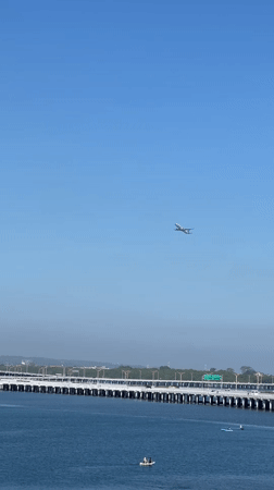 Aircraft observed flying over coastal bridge near Kuta, Indonesia
