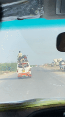 Person, motorcycle spotted riding atop minivan on Pakistani highway