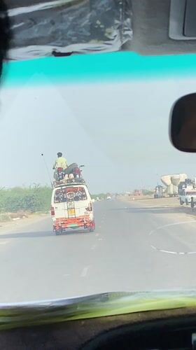 Person, motorcycle spotted riding atop minivan on Pakistani highway