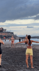 Evening beach recreation captured at North Kuta's volcanic shores