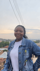 Woman photographs cityscape during afternoon session in Jos, Nigeria