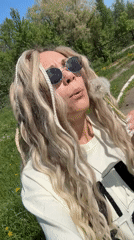Person enjoys spring morning with dandelions in Russian field