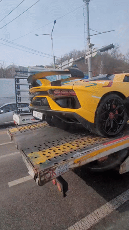 Yellow Lamborghini towed on flatbed truck in Incheon