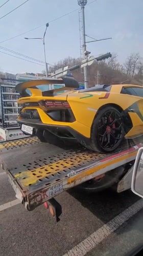Yellow Lamborghini towed on flatbed truck in Incheon