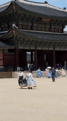 Morning visitors explore Gyeongbokgung Palace in traditional Korean attire