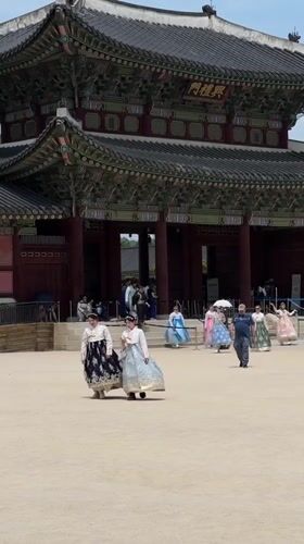 Morning visitors explore Gyeongbokgung Palace in traditional Korean attire