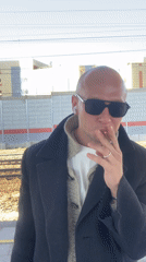 Man in sunglasses observed on Moscow train platform