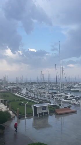 Rain rolls into Punta Ala marina on a cloudy morning