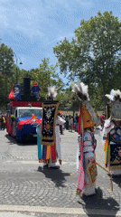Colorful street parade fills central Paris on a summer afternoon