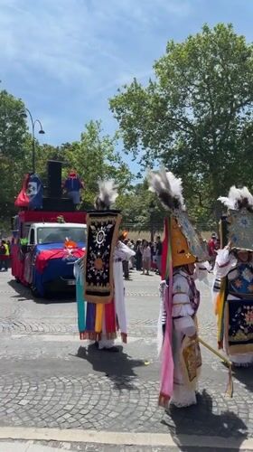 Colorful street parade fills central Paris on a summer afternoon