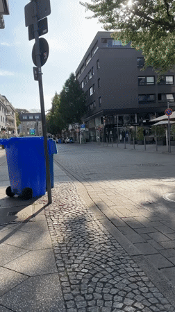 Krefeld pedestrian street, lampshades overhead, cafes open for the day