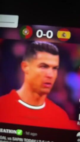 This is a screen recording of a soccer match shown on a mobile device. The score is 0-0 between Portugal and Spain. A player with blonde, spiky hair is in the foreground, wearing a neon yellow jersey with the number 19. The screen then shifts to show a wider view of the soccer field with players on the grass and a stadium crowd in the background. Finally, the screen focuses on Cristiano Ronaldo in a red jersey, looking to the right. The bottom of the screen displays a video title that reads "PORTUGAL vs SAPIN TODAY | 7-5 | Full Match Highlights | FIFA Worldcup 20...".