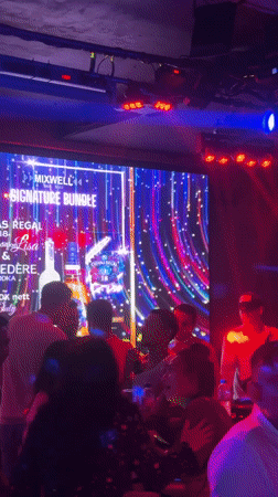 Kuta nightclub bustling with socializing patrons and dancing