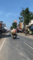 Motorcycles and street food stalls on a Kediri City road