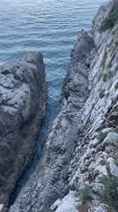 Coastal inlet filmed between rocky cliffs in Budva